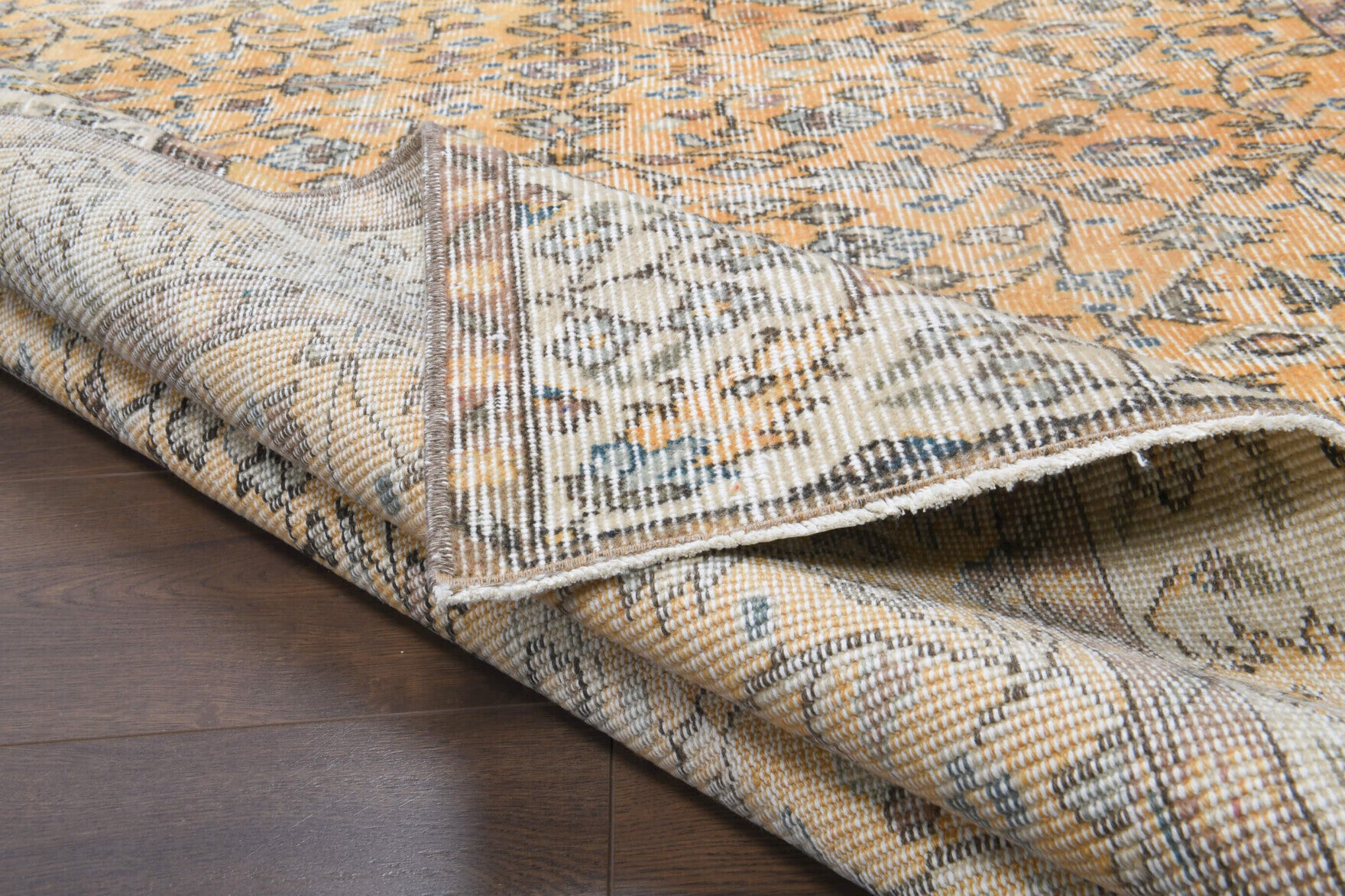 Safirpeyker rug: 1970s handmade Anatolian rug with bordered and floral motifs and cotton backing