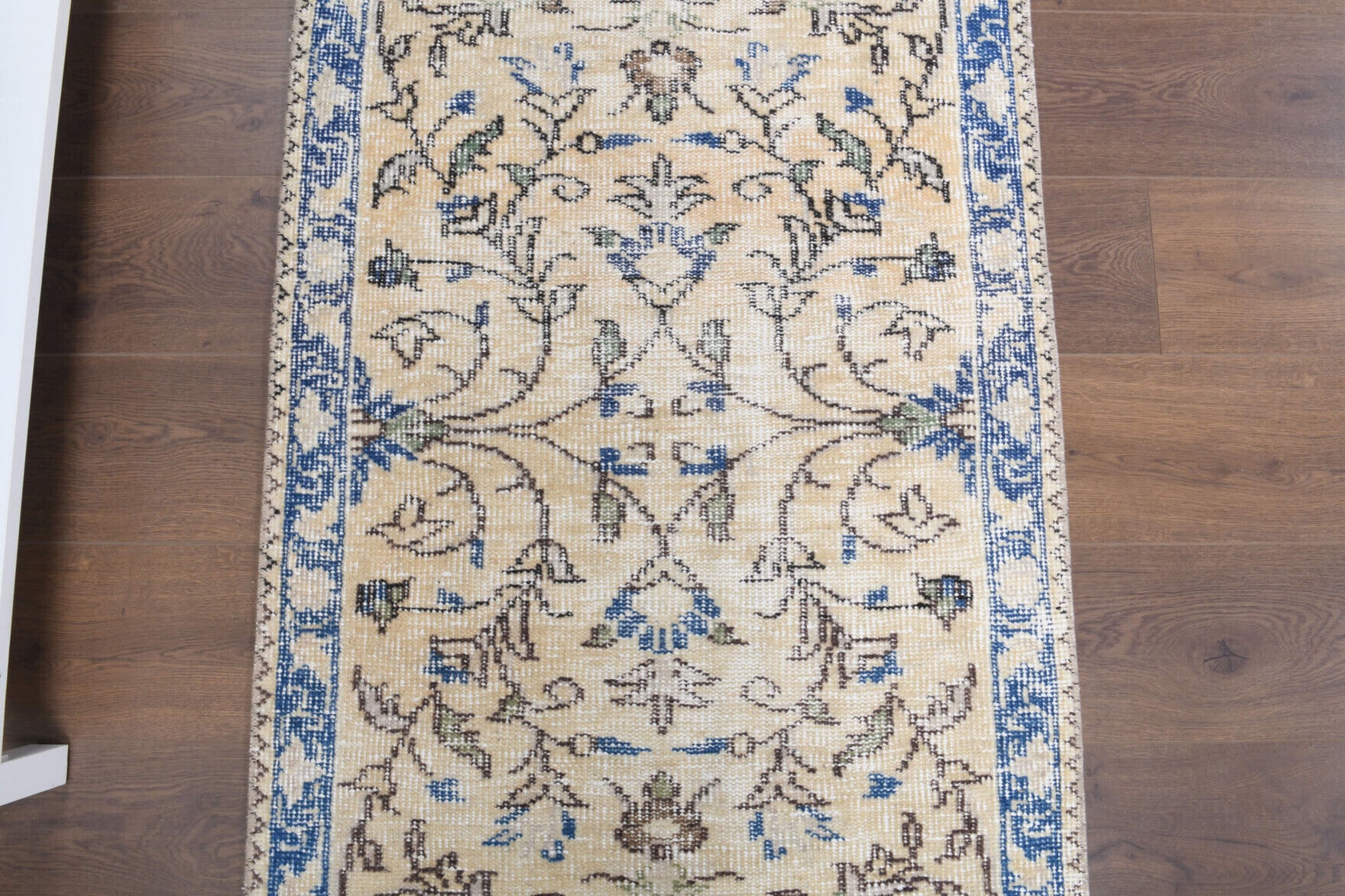 Kelebekperver runner: 1970s handmade Anatolian runner with floral motifs and cotton backing
