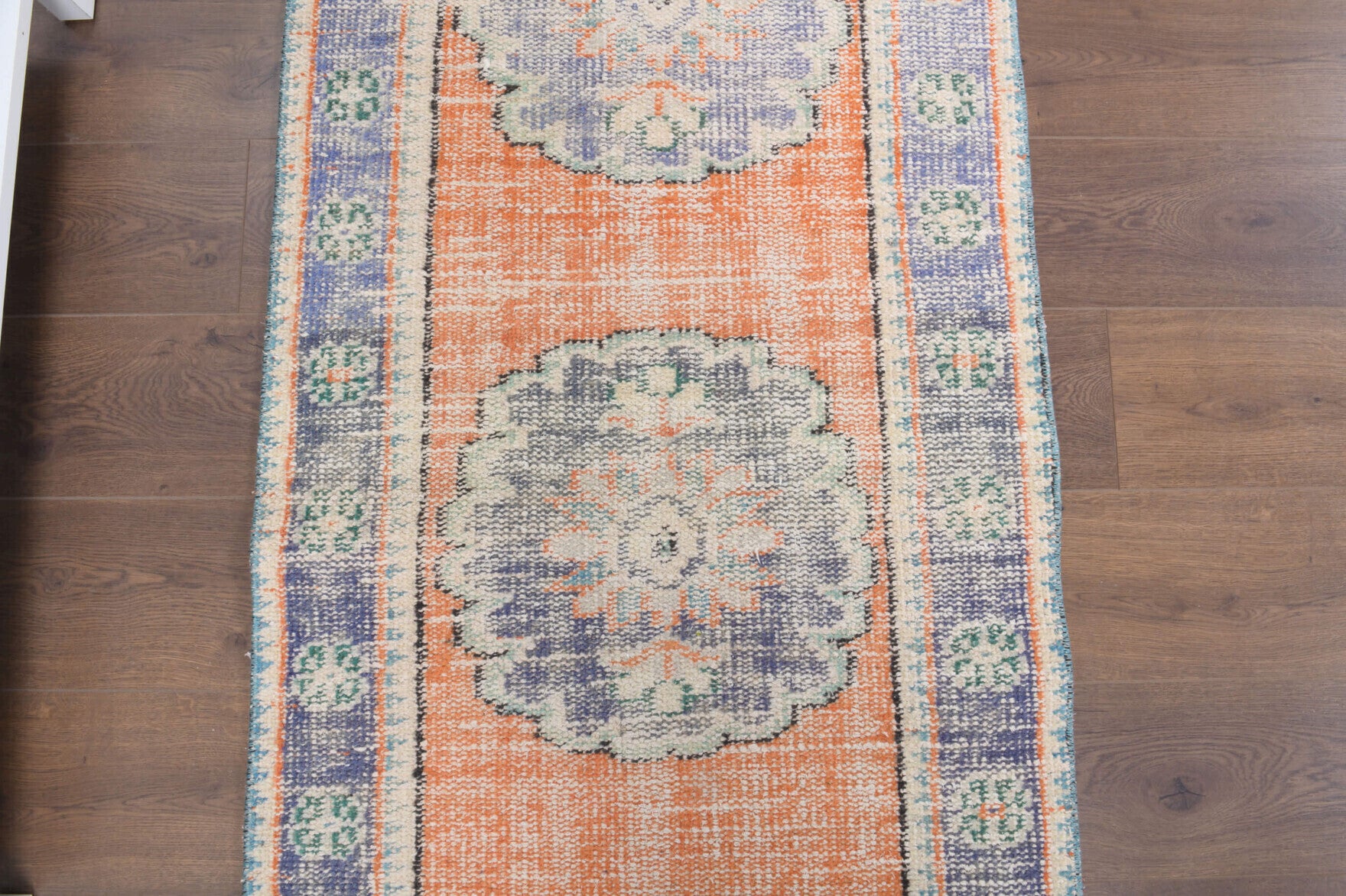 Kelebekpare runner: 1970s handmade Anatolian runner with oriental motifs and cotton backing