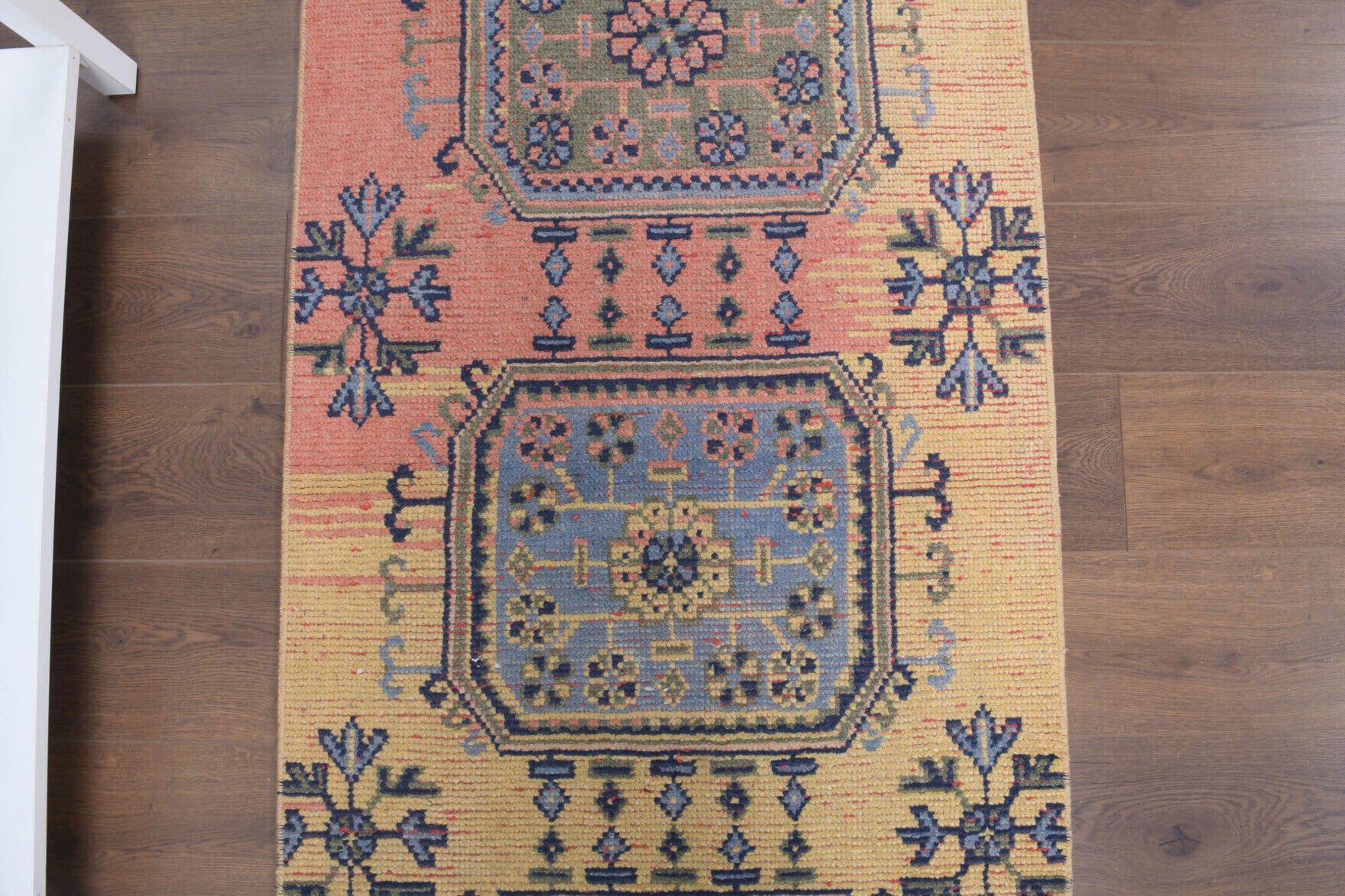 Kayakoy runner: 1970s handmade Anatolian runner with floral motifs and cotton backing