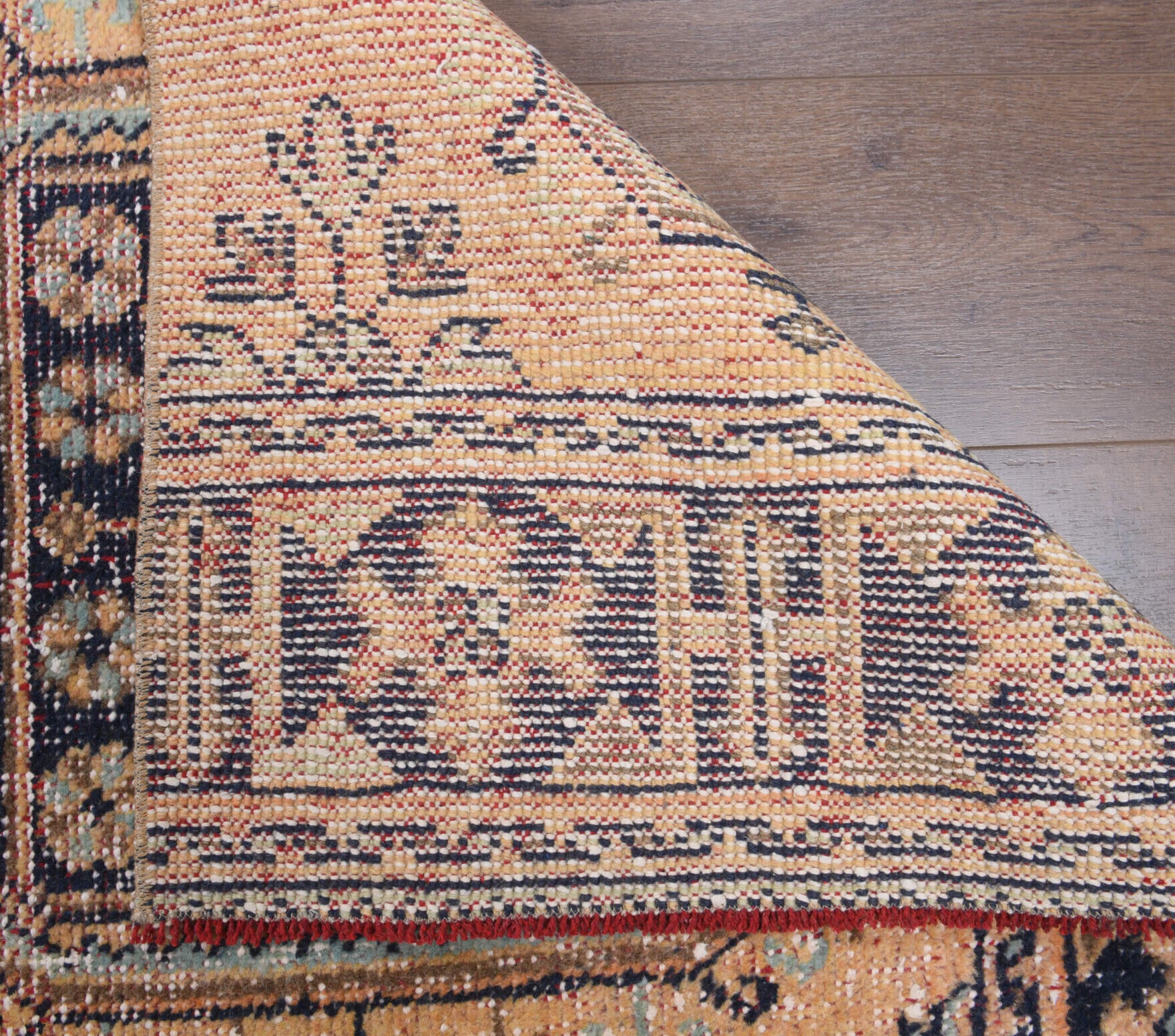 Ioniaphrosyne runner: 1970s handmade Anatolian runner with floral motifs and cotton backing